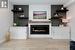 Contemporary fireplace with shiplap backdrop and floating shelves.