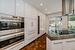 Kitchen featuring double wall ovens & wine column