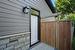 Side entrance to garage with stone walkway from driveway