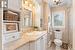 Main bathroom, marble countertop, tile floor. Updated faucets and shower head. Kohler toilet and sink. Extensive white built in cabinetry. Antique chandelier.