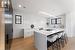 Kitchen. Quartz countertops. Thermador microwave fridge and freezer are hidden in black cabinetry to the left.