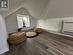 Living area featuring dark hardwood / wood-style floors, vaulted ceiling, and heating unit