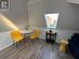 Sitting room with dark hardwood / wood-style flooring and vaulted ceiling