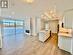 Kitchen with a center island with sink, white cabinetry, light hardwood / wood-style floors, and sink