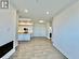 Kitchen with white cabinets, crown molding, light wood-type flooring, and sink