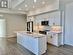 Kitchen featuring white cabinets, sink, light hardwood / wood-style flooring, an island with sink, and stainless steel appliances