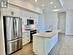 Kitchen with a kitchen island with sink, sink, white cabinets, and stainless steel appliances