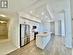 Kitchen with light wood-type flooring, stainless steel appliances, sink, white cabinetry, and an island with sink