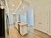 Kitchen with white cabinets, sink, an island with sink, light hardwood / wood-style floors, and stainless steel appliances