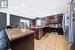 Kitchen featuring stainless steel appliances, kitchen peninsula, light tile patterned floors, sink, and lofted ceiling