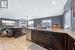 Kitchen with lofted ceiling, dark brown cabinets, sink, and dishwasher