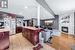 Kitchen featuring light hardwood / wood-style flooring, a fireplace, stainless steel refrigerator with ice dispenser, and a center island