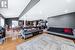 Living room with decorative columns, lofted ceiling, and hardwood / wood-style flooring