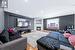 Living room featuring light hardwood / wood-style floors, a stone fireplace, and lofted ceiling