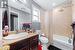 Full bathroom featuring toilet, shower / tub combo, vanity, and tile patterned flooring