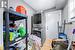 Laundry room with stacked washer and dryer and light tile patterned floors