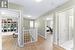 Hallway with light hardwood / wood-style flooring and a textured ceiling