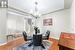 Dining area featuring hardwood / wood-style floors and a notable chandelier