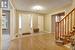 Foyer entrance featuring light laminate flooring and a textured ceiling