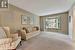 Carpeted living room with a textured ceiling