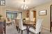 Carpeted dining area with a chandelier and a textured ceiling