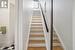 Staircase featuring wood-type flooring