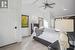 Bedroom featuring light wood-type flooring, vaulted ceiling with beams, and ceiling fan