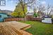 Wooden deck featuring a lawn, a mountain view, and a shed