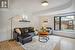 Living room with light hardwood / wood-style floors and beam ceiling