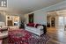 Living room featuring beamed ceiling, wood-type flooring, crown molding, and coffered ceiling