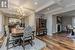 Dining area with hardwood / wood-style flooring, beamed ceiling, and coffered ceiling