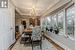 Dining area with crown molding, dark hardwood / wood-style floors, beam ceiling, coffered ceiling, and a chandelier