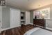 Bedroom featuring dark hardwood / wood-style flooring and crown molding