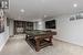 Recreation room with pool table and light colored carpet