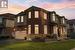 View of front of house featuring a lawn and a garage