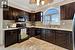 Kitchen with dark brown cabinetry, black appliances, decorative backsplash, and sink