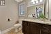 Bathroom featuring ornamental molding, vanity, and toilet