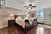 Bedroom featuring ornamental molding, ceiling fan, and dark hardwood / wood-style floors