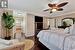 Bedroom featuring ceiling fan, crown molding, dark hardwood / wood-style flooring, and connected bathroom