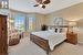 Bedroom featuring ceiling fan and light carpet