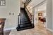 Stairway with a fireplace, ornamental molding, and ornate columns