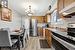 Kitchen featuring sink, stainless steel appliances, ventilation hood, light hardwood / wood-style floors, and pendant lighting