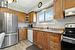 Kitchen featuring light hardwood / wood-style flooring, sink, decorative backsplash, stainless steel appliances, and light stone counters