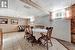 Dining space with wooden walls, light tile patterned floors, and a paneled ceiling