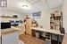 Home office with a paneled ceiling and light wood-type flooring