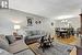 Living room with an inviting chandelier and hardwood / wood-style flooring