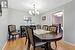 Dining space featuring light hardwood / wood-style floors and a notable chandelier