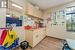 Kitchen featuring cream cabinetry, a drop ceiling, light wood-type flooring, and sink