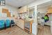 Bar featuring a drop ceiling, light hardwood / wood-style floors, and light brown cabinetry