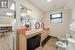 Bathroom with plenty of natural light, a drop ceiling, toilet, and wood-type flooring